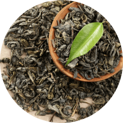 A bowl of vibrant green tea leaves, illustrating the natural source of L-Theanine, a key amino acid used in Revvl Sleep to promote relaxation and improve sleep quality.